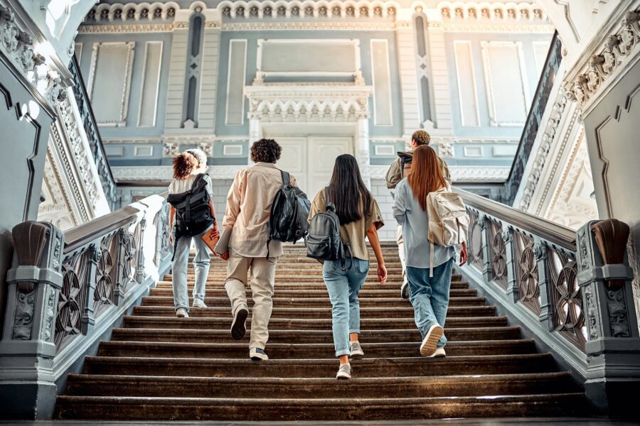 A group of college students walking up the stairs