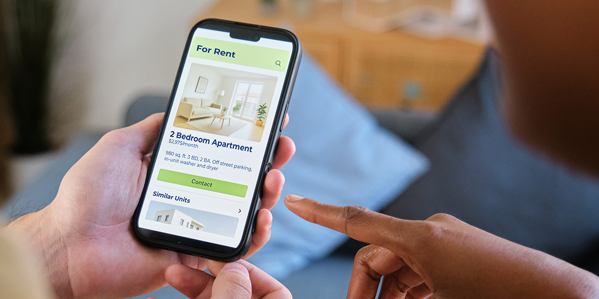 Couple browsing apartment listings on a smartphone application