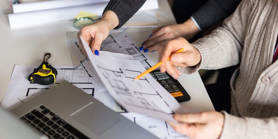 Young property manager consult with his superior on floorplans